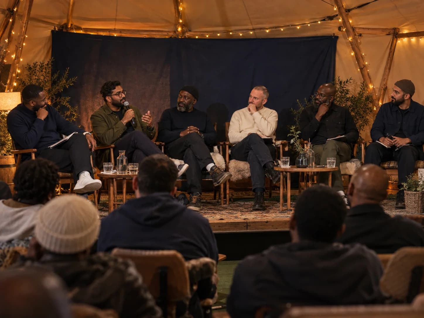 A panel of men in conversation